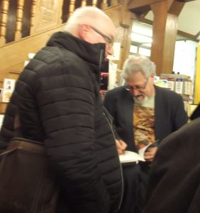 John Bolland, signing a copy of his book, Fallen Stock