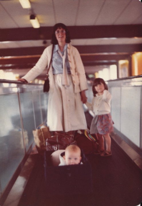 Baby in a carrycot, toddler and me on a travelator at Heathrow